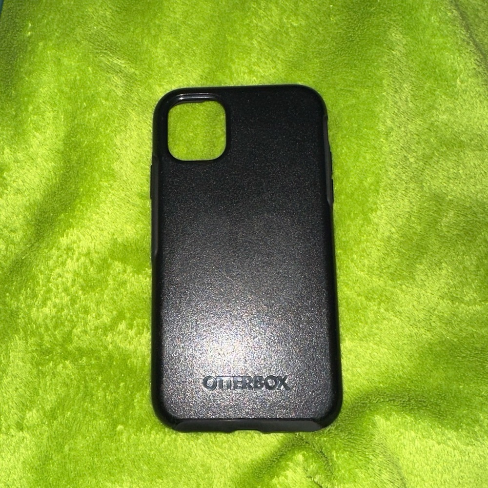 All iPhone 11 phone cases: Green Silicon, Black Otterbox, and Black Wallet Case